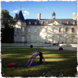 Elissa doing yoga in front of the Château de Verderonne, Image source: Quail Bell Magazine